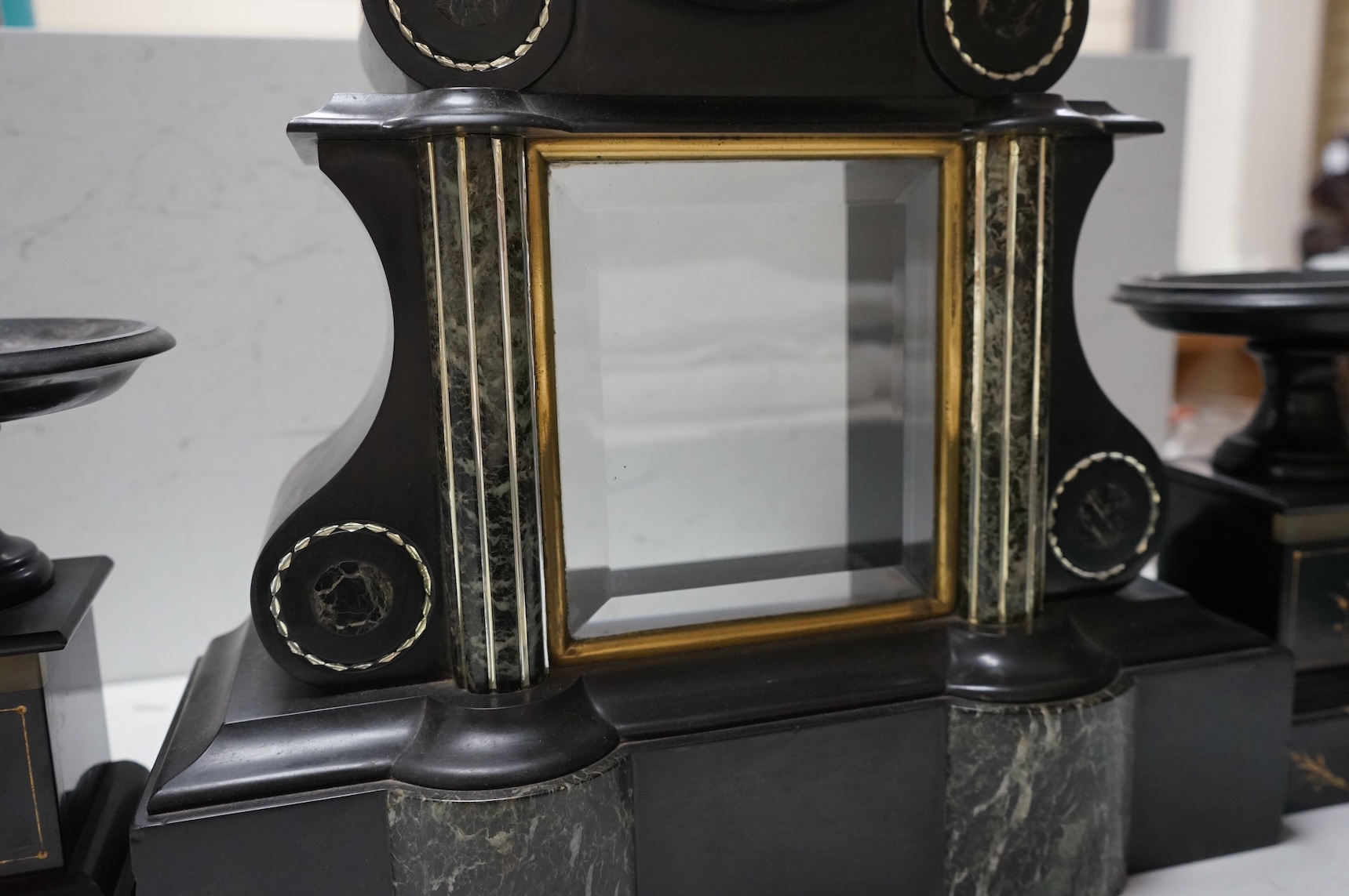 A Victorian slate clock garniture with enamelled chapter ring and mercury pendulum, 47cm high
